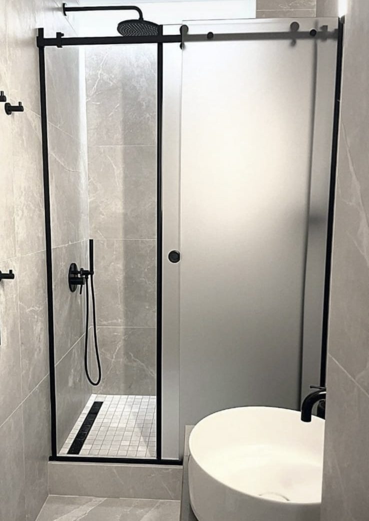 Modern bathroom with walk-in shower and matte black fixtures